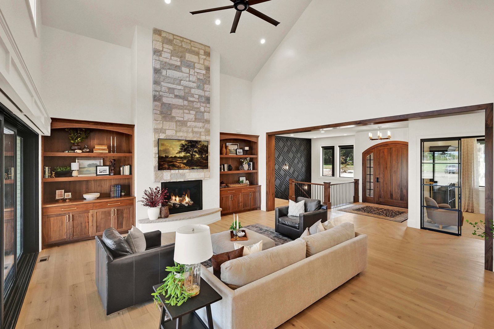 North of Creekside great room with a stone fireplace and vaulted ceiling, 2026 Top of Utah Parade of Homes