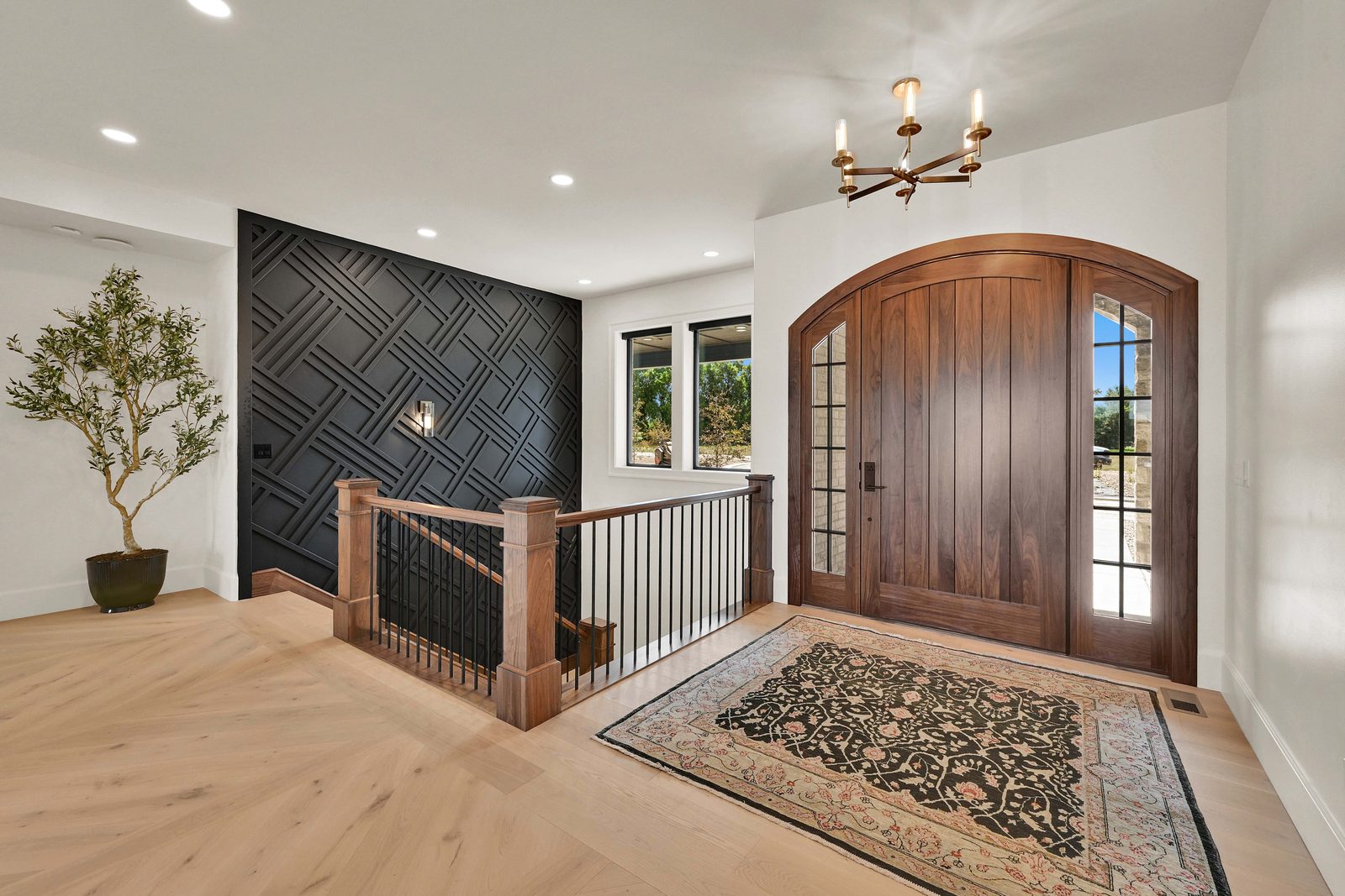 North of Creekside entry foyer with arched wood door and staircase, 2026 Top of Utah Parade of Homes