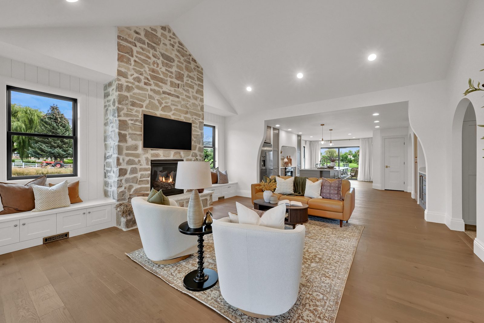 The Lucy living room centered on the stone fireplace, 2025 Top of Utah Parade of Homes