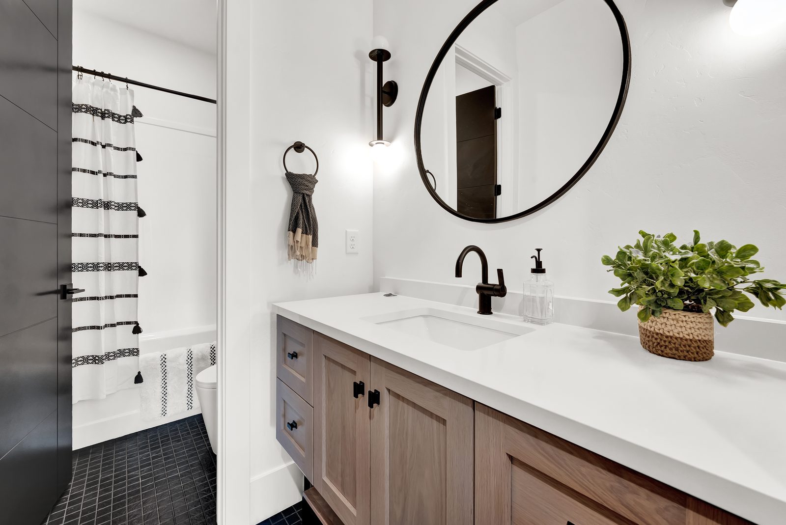 Valley View Estate bathroom with wood vanity and round mirror, 2023 Top of Utah Parade of Homes